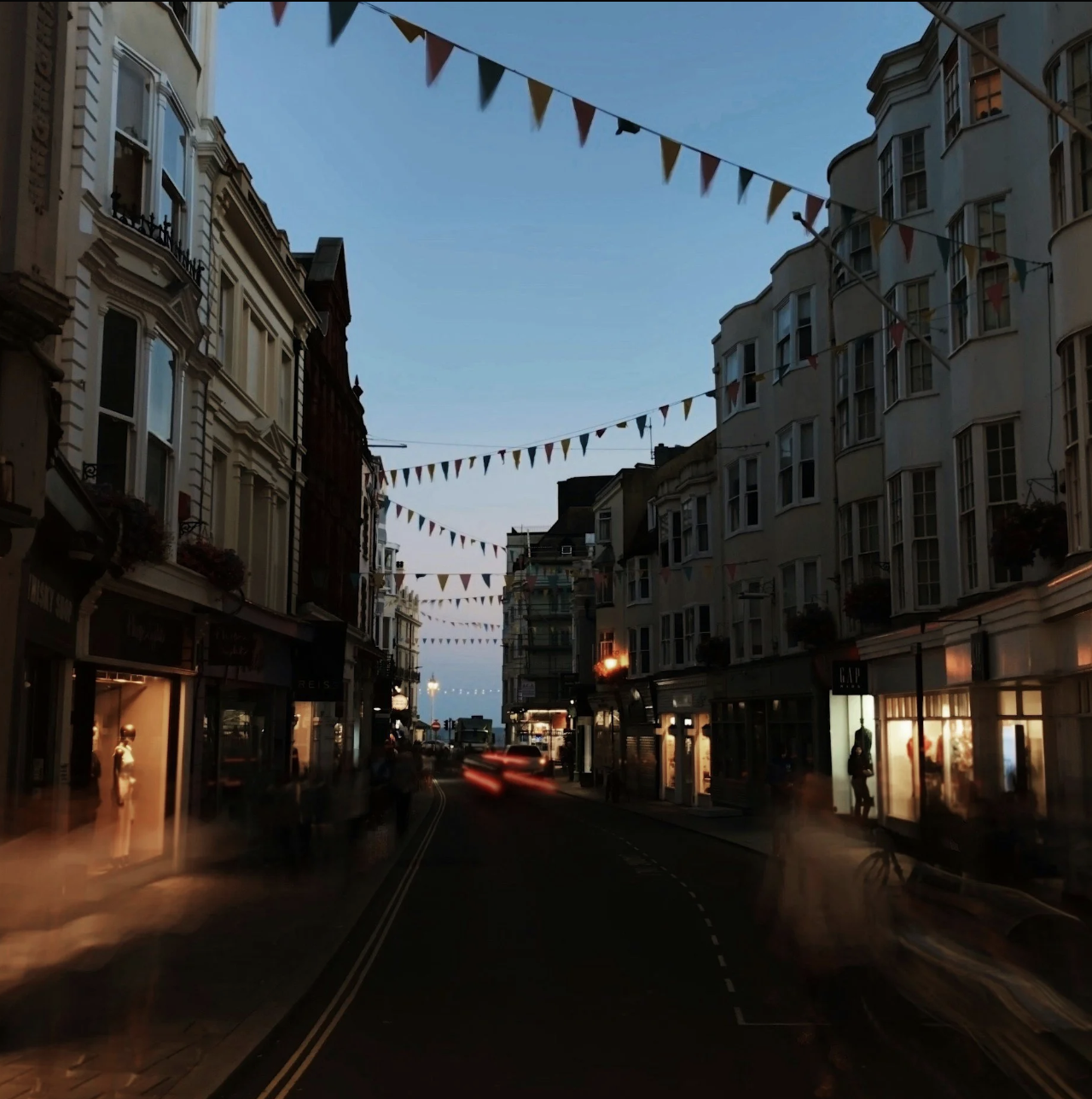 Brighton lanes at dusk with bunting strung above the street